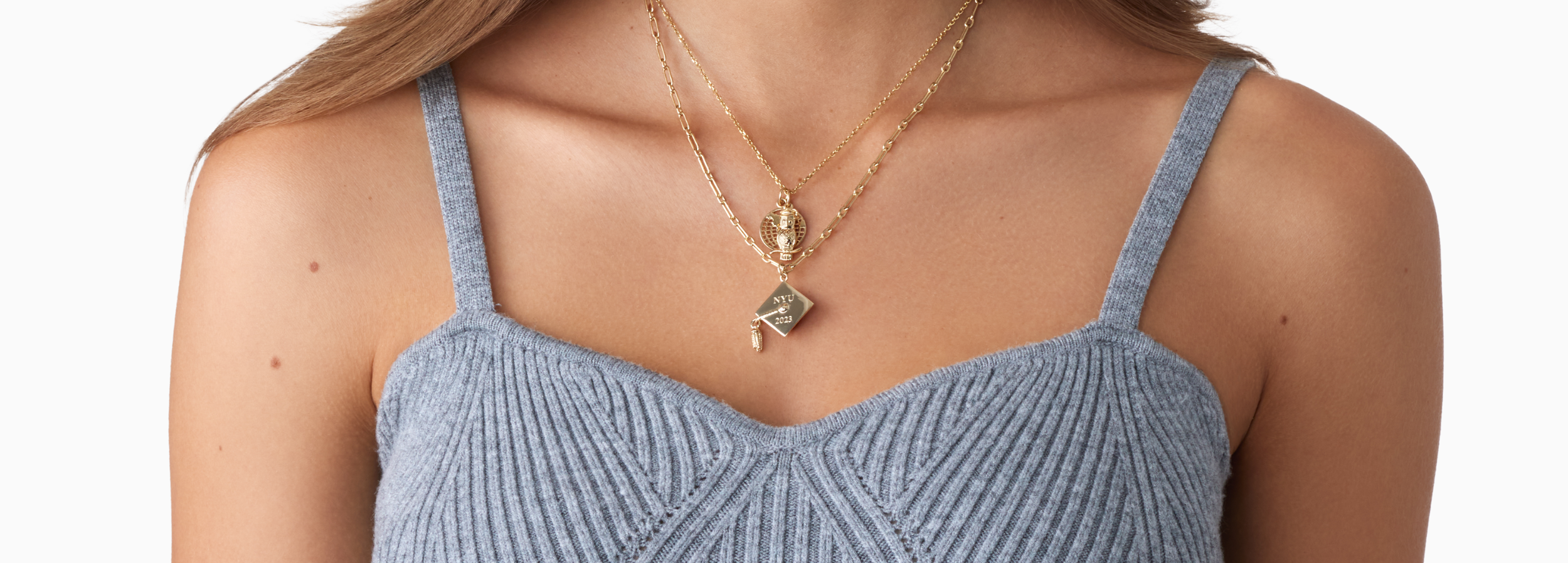graduate wearing new gifted charm necklace
